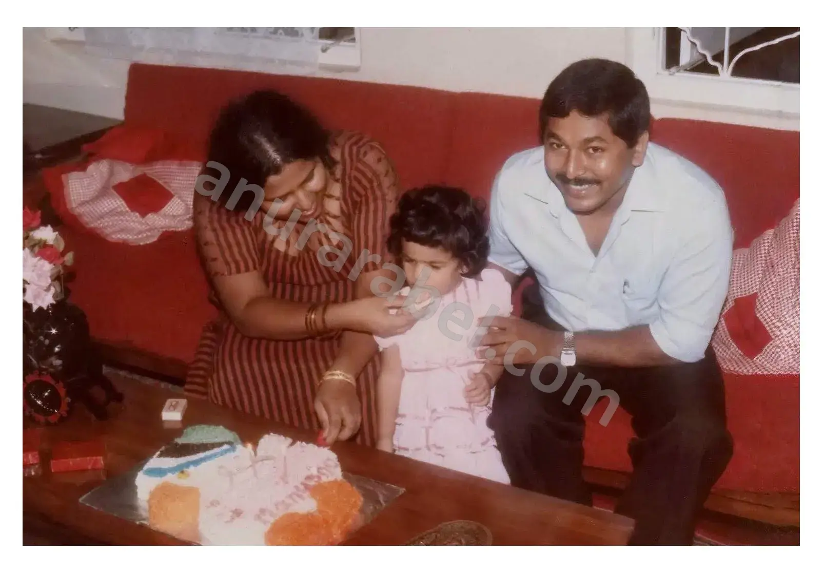 Manusha (Elder Daughter) being fed by Anura Rabel (Father) and Jayamini Rabel (Mother)