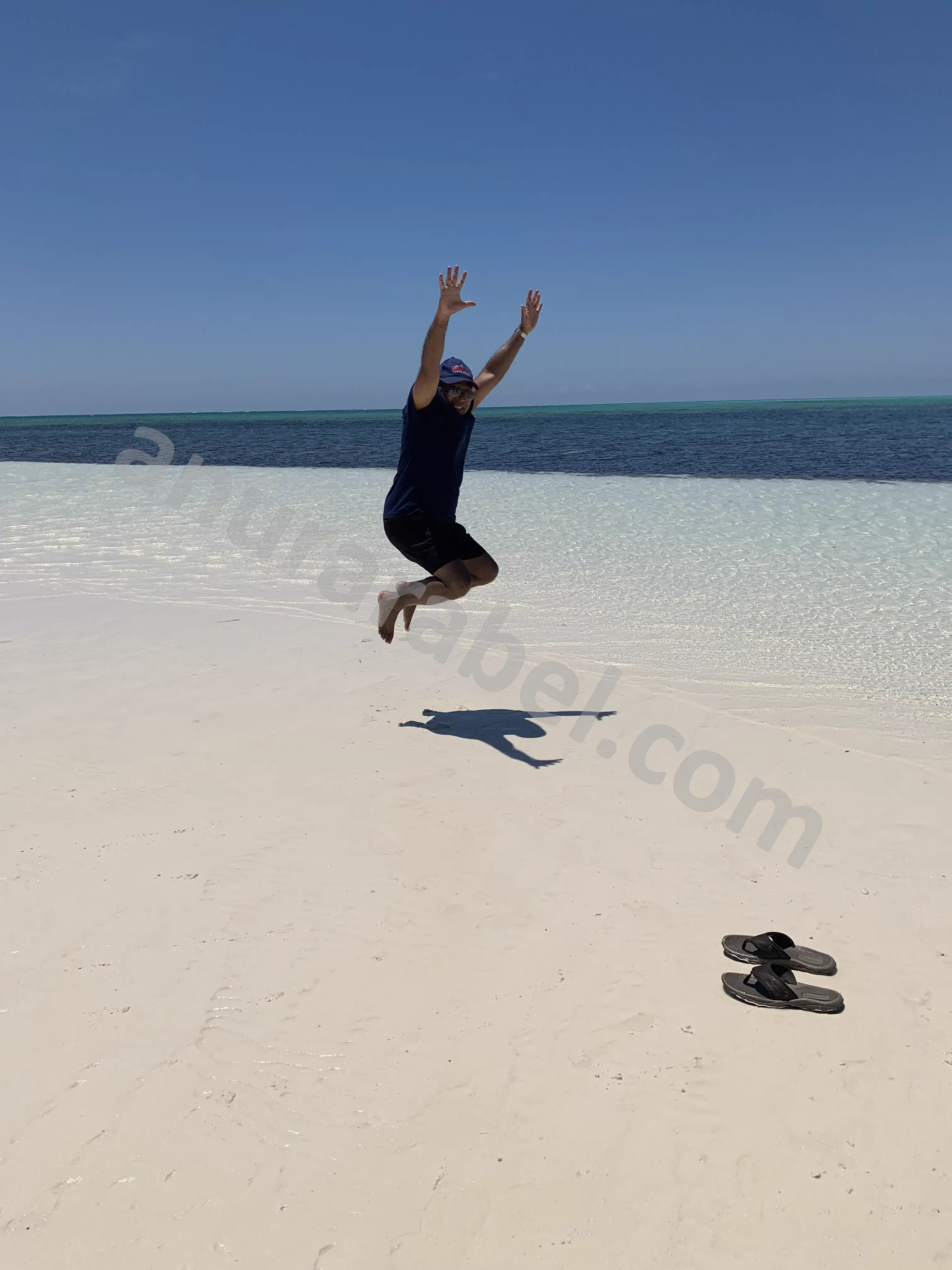 Anura jumping with joy with family Jayamini, Chamara, Ruwanthi, and Ruwanthi's dad at Banana Bay beach in Grand Bahama, Bahamas